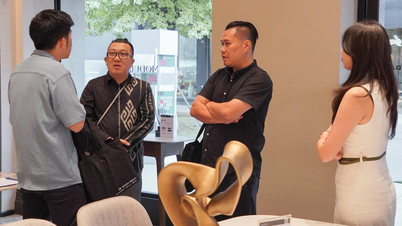Guests engaged in conversation next to a sculptural centerpiece inside the ZBOM showroom