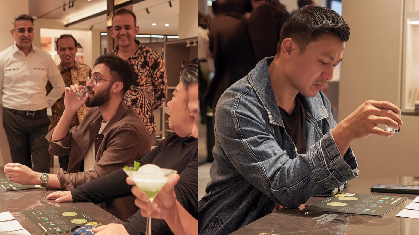 Guests enjoying cocktails at Sundown & Spaces, seated around a table with personalized drinks.