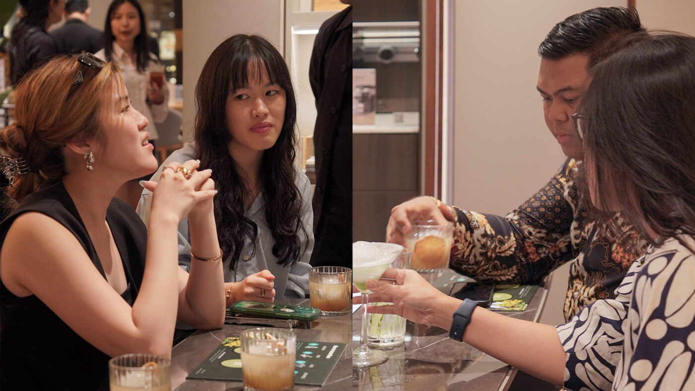 Guests enjoying cocktails at Sundown & Spaces, seated around a table with personalized drinks.